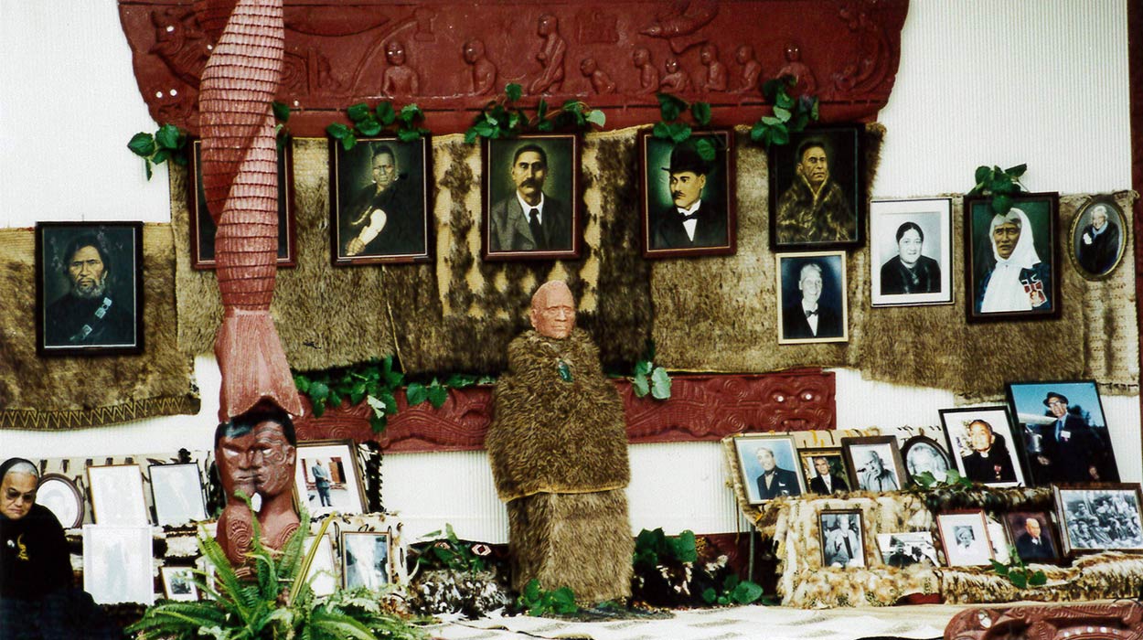 A display of framed photographs of tuupuna (ancestors) and kaakahu (cloaks).